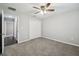 Bedroom featuring neutral walls, gray carpet, ceiling fan, and closet at 13227 Quigley Ave, Weeki Wachee, FL 34614