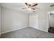 Bedroom featuring gray carpet, a ceiling fan, and a closet at 13227 Quigley Ave, Weeki Wachee, FL 34614