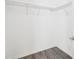 Walk-in closet featuring wire shelving for storage and wood-look tile flooring at 13227 Quigley Ave, Weeki Wachee, FL 34614