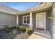 Inviting front entryway with stone pillar accents and neutral siding at 13227 Quigley Ave, Weeki Wachee, FL 34614