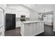 Contemporary kitchen with black appliances, granite countertops, and a central island at 13227 Quigley Ave, Weeki Wachee, FL 34614