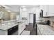 Bright kitchen features granite countertops, white cabinetry, and stainless steel appliances at 13227 Quigley Ave, Weeki Wachee, FL 34614
