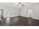 Open concept living space with dark hardwood floors and easy access to the outside at 13227 Quigley Ave, Weeki Wachee, FL 34614