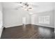 Spacious living room with dark hardwood floors, fan, and natural light at 13227 Quigley Ave, Weeki Wachee, FL 34614