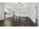 Open-concept living room featuring dark hardwood floors and vaulted ceilings at 13227 Quigley Ave, Weeki Wachee, FL 34614