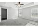 Carpeted main bedroom with trey ceiling, fan, and lots of natural light at 13227 Quigley Ave, Weeki Wachee, FL 34614