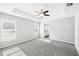 Spacious main bedroom features tray ceiling, fan, and large windows at 13227 Quigley Ave, Weeki Wachee, FL 34614