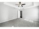 Airy main bedroom featuring trey ceiling, fan, and carpeted flooring at 13227 Quigley Ave, Weeki Wachee, FL 34614