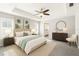 Relaxing main bedroom with palm tree art, plush bedding, and ensuite bathroom access at 13227 Quigley Ave, Weeki Wachee, FL 34614