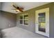 Covered outdoor patio with a ceiling fan and access to backyard at 13227 Quigley Ave, Weeki Wachee, FL 34614