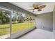 Screened in porch with ceiling fan and a view to the backyard at 13227 Quigley Ave, Weeki Wachee, FL 34614