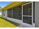 Screened porch featuring green grass, sliding glass doors, and ceiling fan at 13227 Quigley Ave, Weeki Wachee, FL 34614