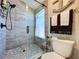 Beautiful bathroom featuring tiled shower, neutral color palette, and beach decor at 1445 Stonehenge Way, Palm Harbor, FL 34683