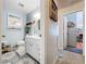 Bathroom with vanity, coastal decor, blue walls, and doorway leading to another room at 1445 Stonehenge Way, Palm Harbor, FL 34683