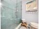 Bathroom with glass enclosed shower with blue tiling and a small wooden step stool at 1445 Stonehenge Way, Palm Harbor, FL 34683