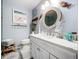 Bathroom with a vanity featuring nautical accents, lighting, and a beach themed photograph at 1445 Stonehenge Way, Palm Harbor, FL 34683