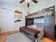 Cozy bedroom featuring bunk beds with nautical-themed decor and stylish striped bedding, illuminated by a ceiling fan at 1445 Stonehenge Way, Palm Harbor, FL 34683