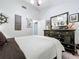 Bedroom features neutral colors, a ceiling fan, and a large dresser with coastal decor at 1445 Stonehenge Way, Palm Harbor, FL 34683