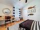 Bedroom featuring a desk, a round nautical themed mirror, and striped curtains at 1445 Stonehenge Way, Palm Harbor, FL 34683