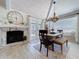 The dining room with a farmhouse-style table, decor, and bench seating is situated near a fireplace and French doors at 1445 Stonehenge Way, Palm Harbor, FL 34683