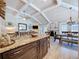 Open layout kitchen with granite countertops, island seating, and open access to the living and dining rooms at 1445 Stonehenge Way, Palm Harbor, FL 34683
