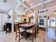 A spacious open kitchen is shown, featuring a kitchen island with seating, light decor, and views to other living areas at 1445 Stonehenge Way, Palm Harbor, FL 34683