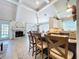 Open-concept kitchen overlooking dining area; features countertop seating and view to the outdoor pool through French doors at 1445 Stonehenge Way, Palm Harbor, FL 34683