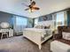 Relaxing main bedroom with soft carpet and decor, reading chair, and writing desk at 1445 Stonehenge Way, Palm Harbor, FL 34683