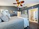 Comfortable main bedroom with decorative accent wall, ensuite bathroom and walk-in closet at 1445 Stonehenge Way, Palm Harbor, FL 34683