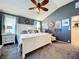 Cozy main bedroom with accent wall, soft carpet, and soothing decor at 1445 Stonehenge Way, Palm Harbor, FL 34683