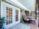 Charming patio with outdoor dining area, blue accents, and a view of the refreshing pool area at 1445 Stonehenge Way, Palm Harbor, FL 34683