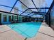 Beautiful screened-in pool with a view of the home's exterior and outdoor entertaining spaces, offering privacy at 1445 Stonehenge Way, Palm Harbor, FL 34683