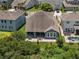 Aerial view of a home with a pool, patio, and green backyard surrounded by lush trees at 14855 Renaissance Ave, Odessa, FL 33556