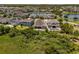 Stunning aerial view of homes surrounding a lake and overlooking well-maintained lawns and mature landscaping at 14855 Renaissance Ave, Odessa, FL 33556