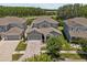 Aerial view of home featuring neutral paint, a two car garage, and a well-maintained lawn at 14855 Renaissance Ave, Odessa, FL 33556