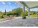 Outdoor patio featuring wicker furniture and a stone fire pit with natural surroundings at 14855 Renaissance Ave, Odessa, FL 33556