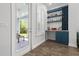 Charming bar area with custom cabinetry, wine rack, and view to the outdoor patio at 14855 Renaissance Ave, Odessa, FL 33556