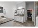 Bright bathroom with double sinks, a large mirror and stone countertops with an open walk in closet at 14855 Renaissance Ave, Odessa, FL 33556