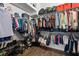 Walk-in closet featuring wood floor and shelving with organized clothes at 14855 Renaissance Ave, Odessa, FL 33556