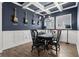 Dining room showcases blue walls, detailed trim work, and guitars mounted on the wall at 14855 Renaissance Ave, Odessa, FL 33556