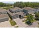 Beautiful exterior of a home displaying a well-kept lawn, tasteful landscaping, and a brick driveway at 14855 Renaissance Ave, Odessa, FL 33556