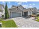 Charming two-story home featuring brick driveway, and a two-car garage at 14855 Renaissance Ave, Odessa, FL 33556