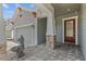 Home featuring a well-maintained lawn, two-car garage, brick driveway, and a water feature at 14855 Renaissance Ave, Odessa, FL 33556