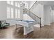 Game room featuring a pool table, large windows, and staircase at 14855 Renaissance Ave, Odessa, FL 33556