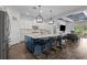 Open kitchen with white cabinets, large island with seating, and adjacent living area at 14855 Renaissance Ave, Odessa, FL 33556
