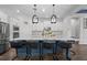 Kitchen with white cabinets, stainless appliances, large island with marble countertop, and seating at 14855 Renaissance Ave, Odessa, FL 33556