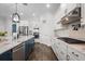 Modern kitchen with white cabinets, stainless steel appliances, and a large island with seating at 14855 Renaissance Ave, Odessa, FL 33556