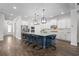 Bright kitchen with white cabinets, stainless appliances, and a large island with seating at 14855 Renaissance Ave, Odessa, FL 33556
