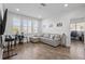 Bright living room with wood floors, large windows, and comfortable seating area at 14855 Renaissance Ave, Odessa, FL 33556