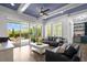 Spacious living room featuring hardwood floors, natural light, and access to a patio at 14855 Renaissance Ave, Odessa, FL 33556
